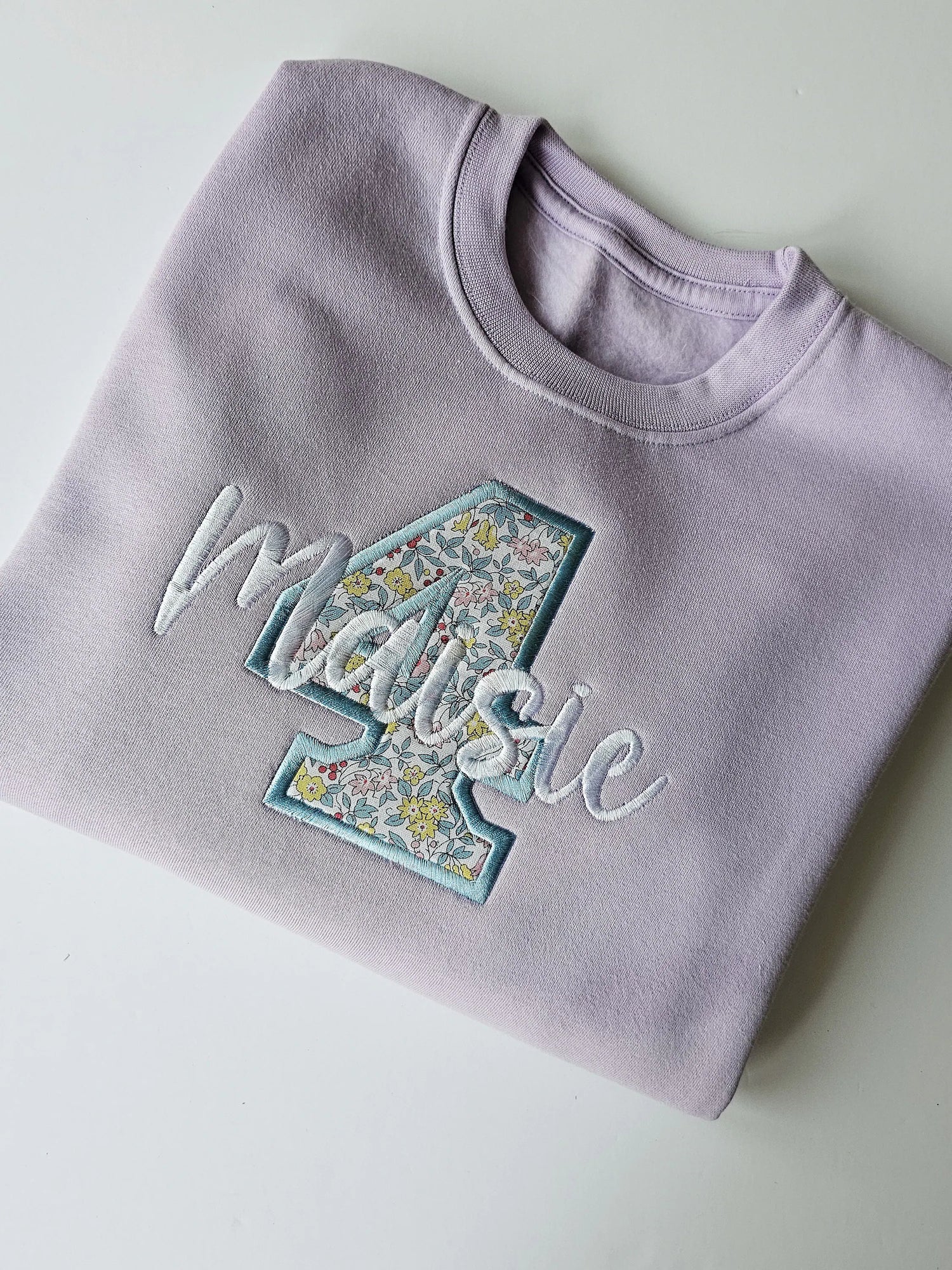 Pastel Purple birthday jumper, embroidered in pastel blue embroidery and white thread with custom name