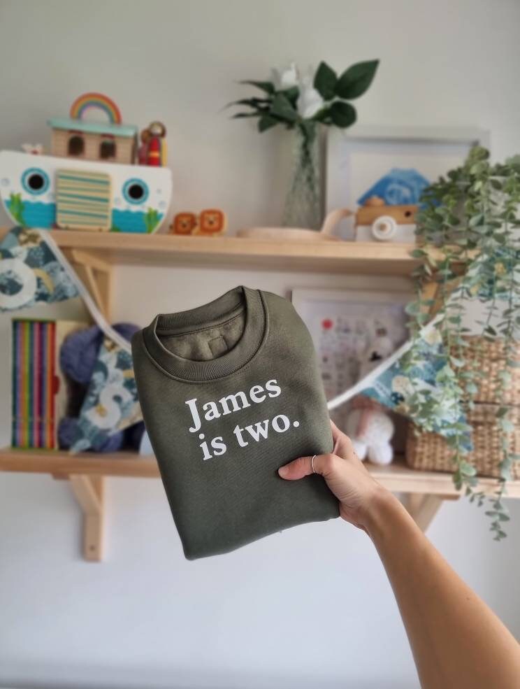 Personalised printed birthday kids jumper with the sentence James is two