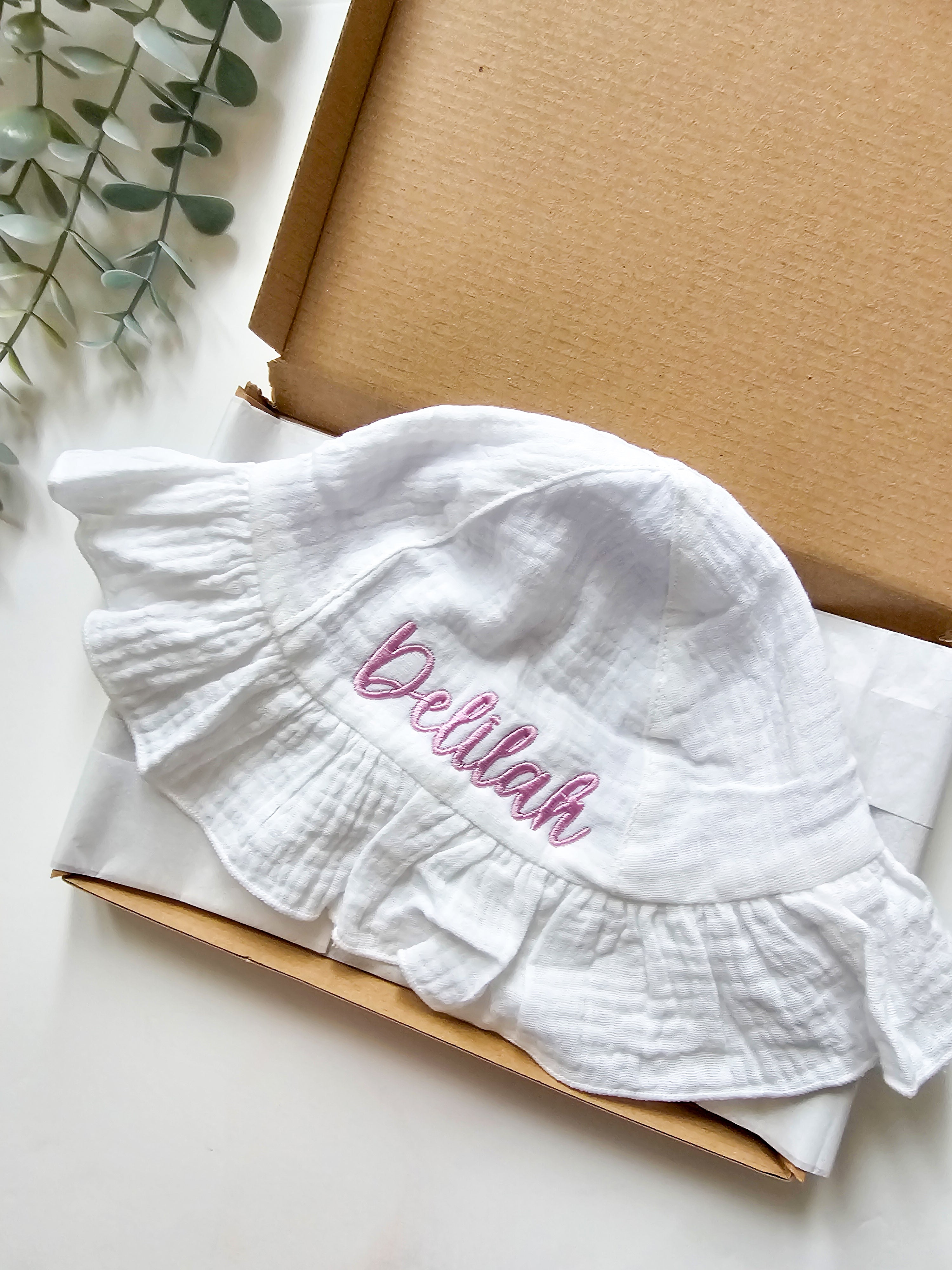 Personalised, embroidered baby sun hat with purple thread.