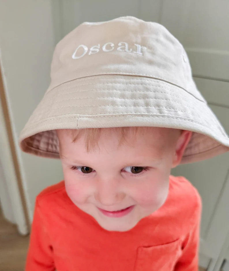 Child wearing personalised embroidered bucket hat