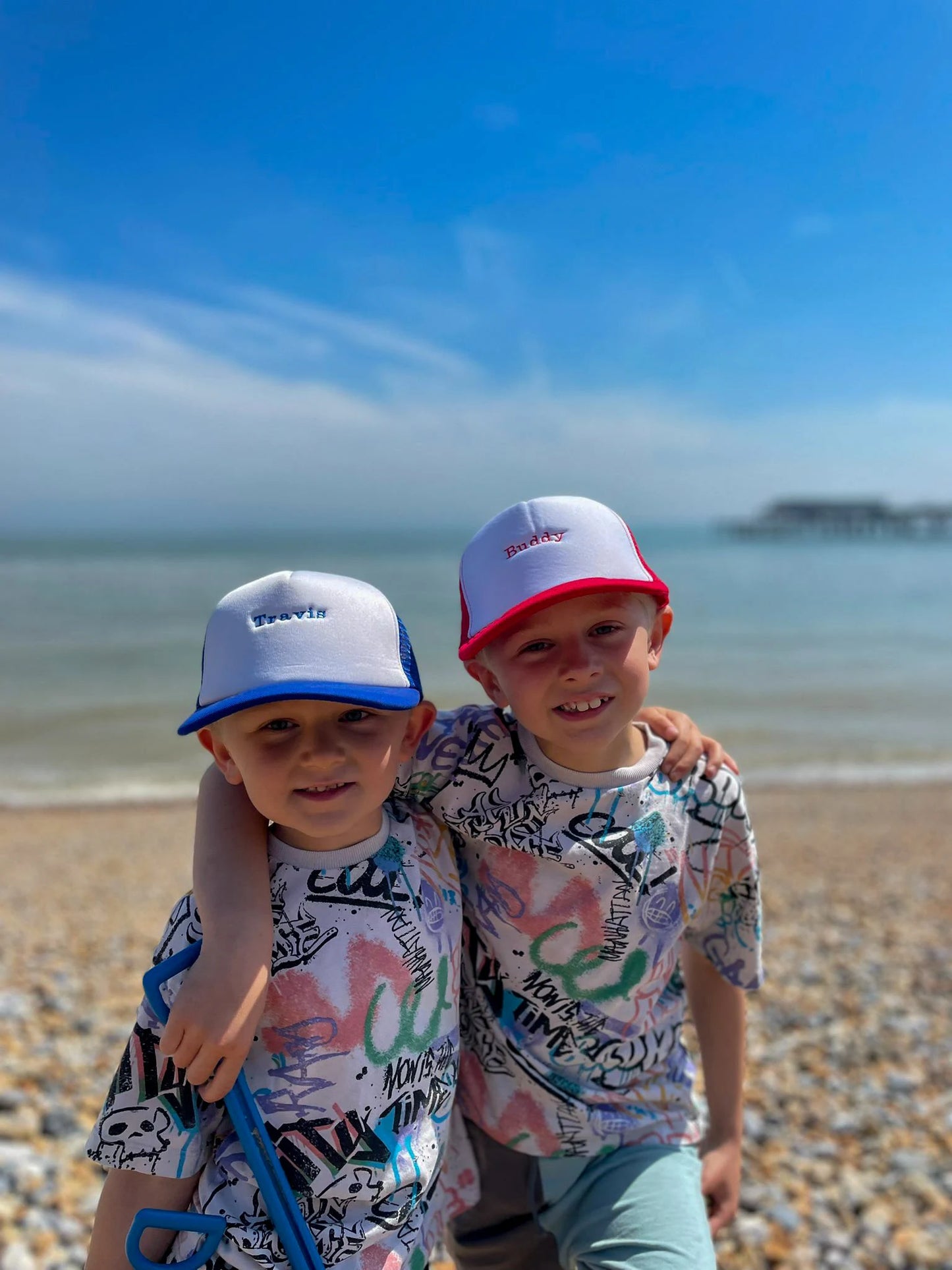 Children wearing matching personalised trucker caps