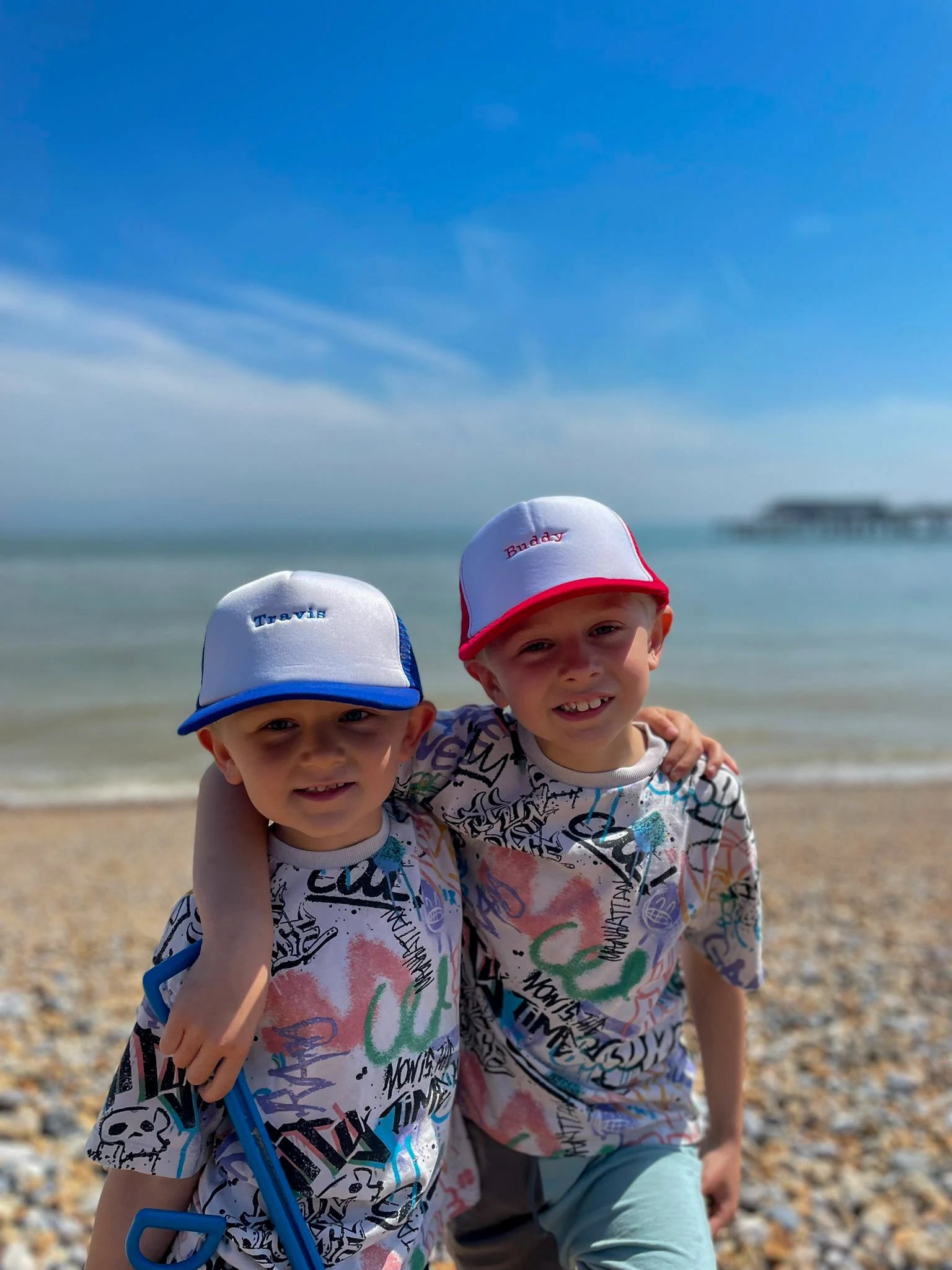 Children wearing matching personalised trucker caps