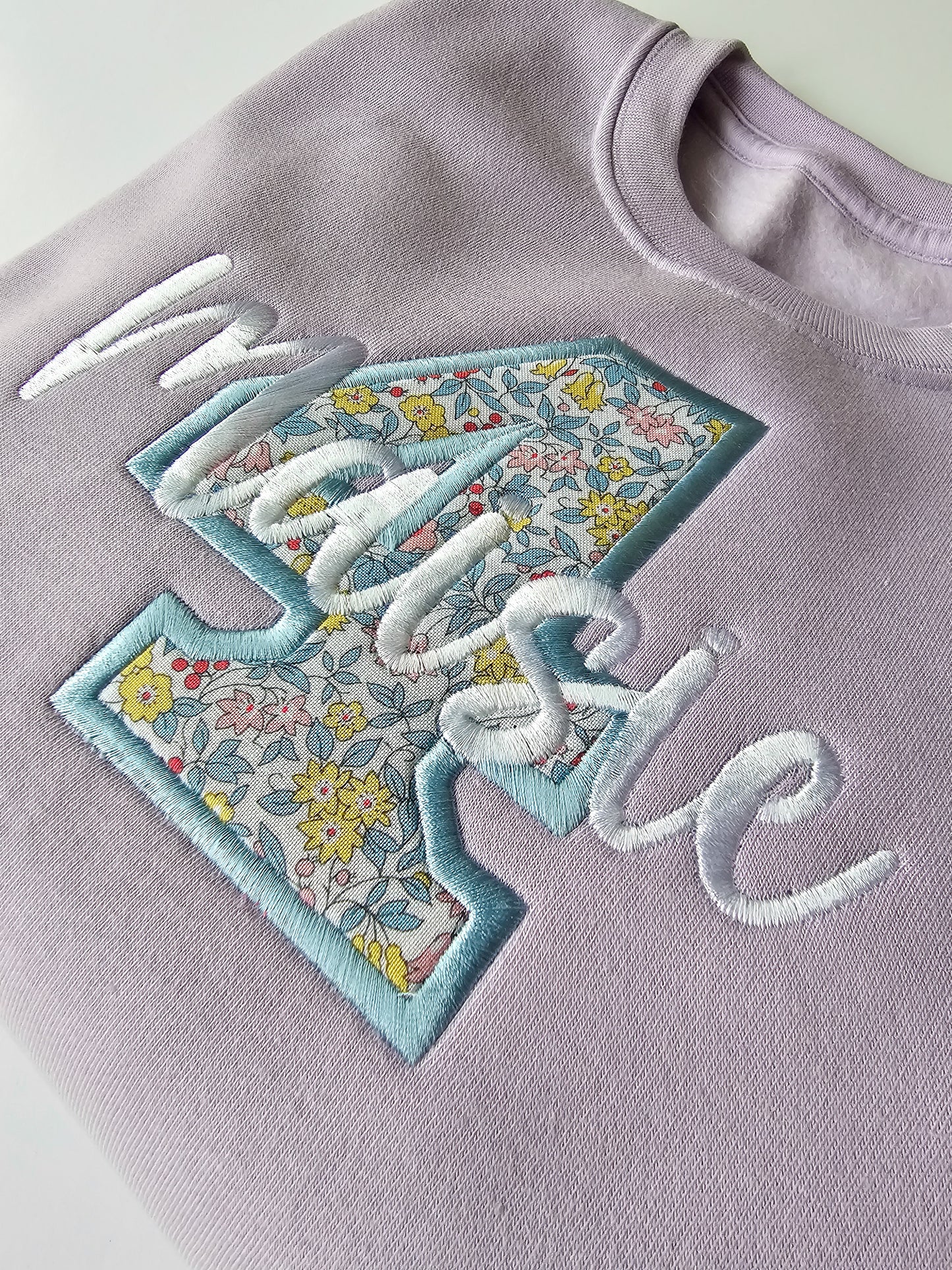 Close up of 4th personalised embroidered kids birthday jumper