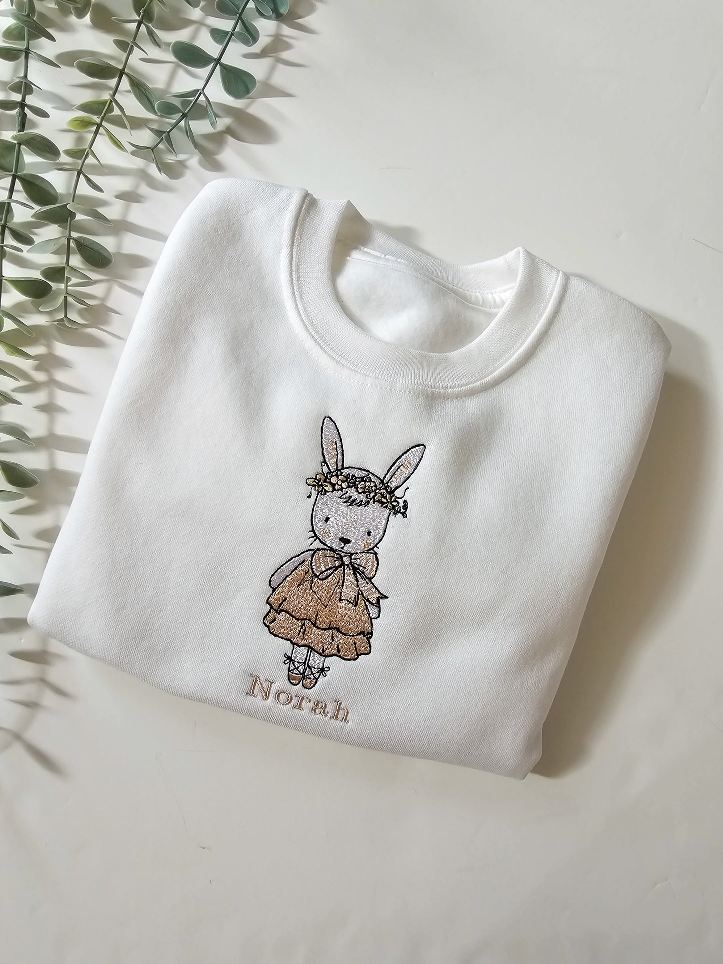 Personalised white children’s jumper with embroidered bunny wearing pink dress and floral flower crown with child’s name