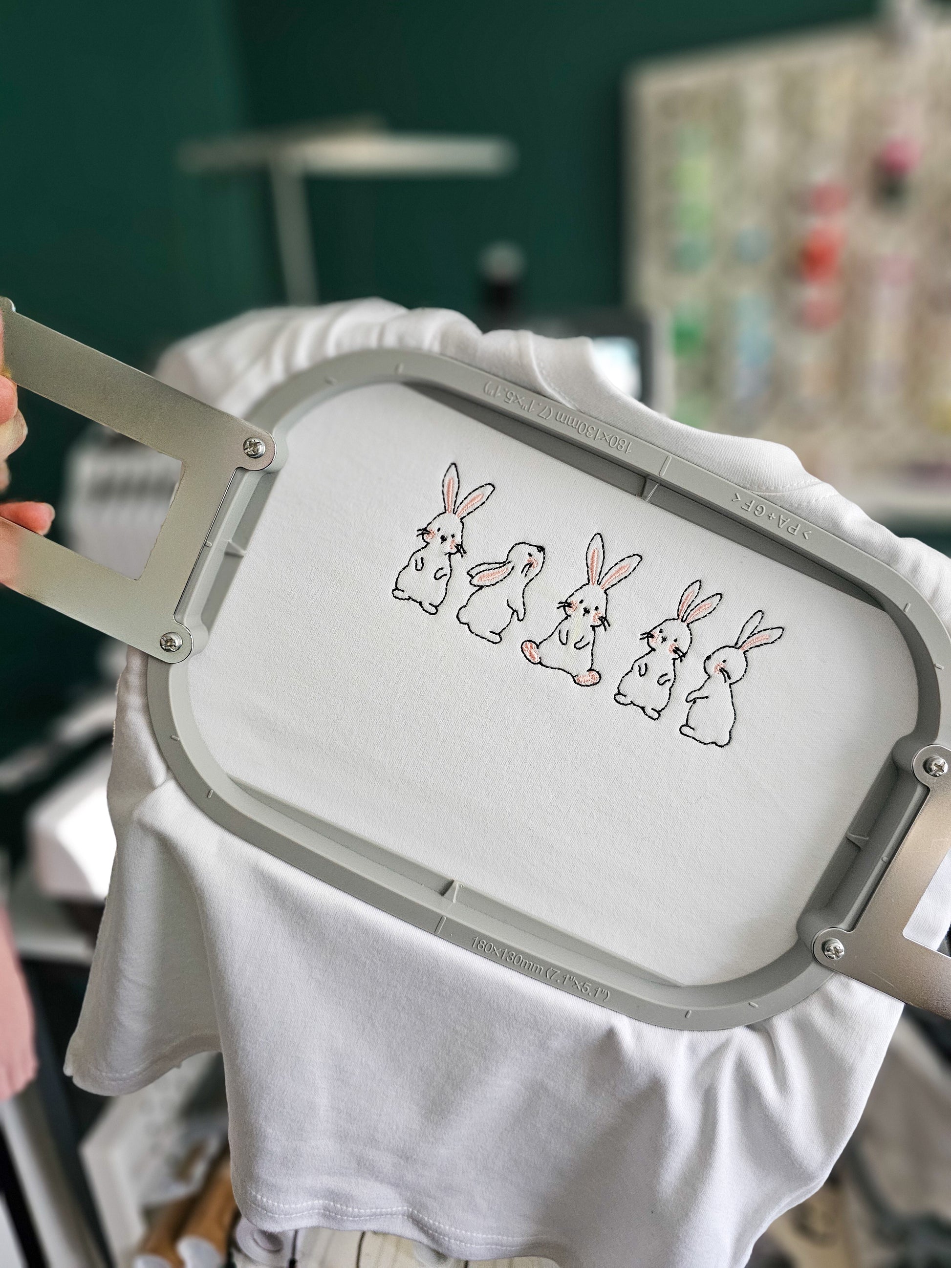 White t-shirt with embroidered bunnies on an embroidery hoop