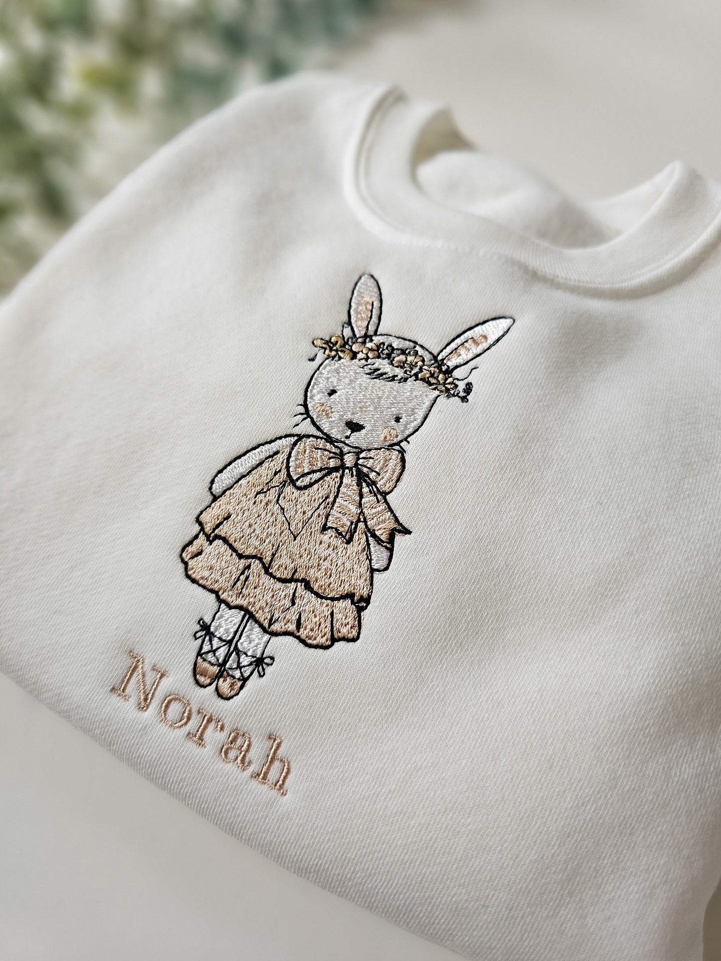 Personalised white children’s jumper with embroidered bunny wearing pink dress and floral flower crown with child’s name