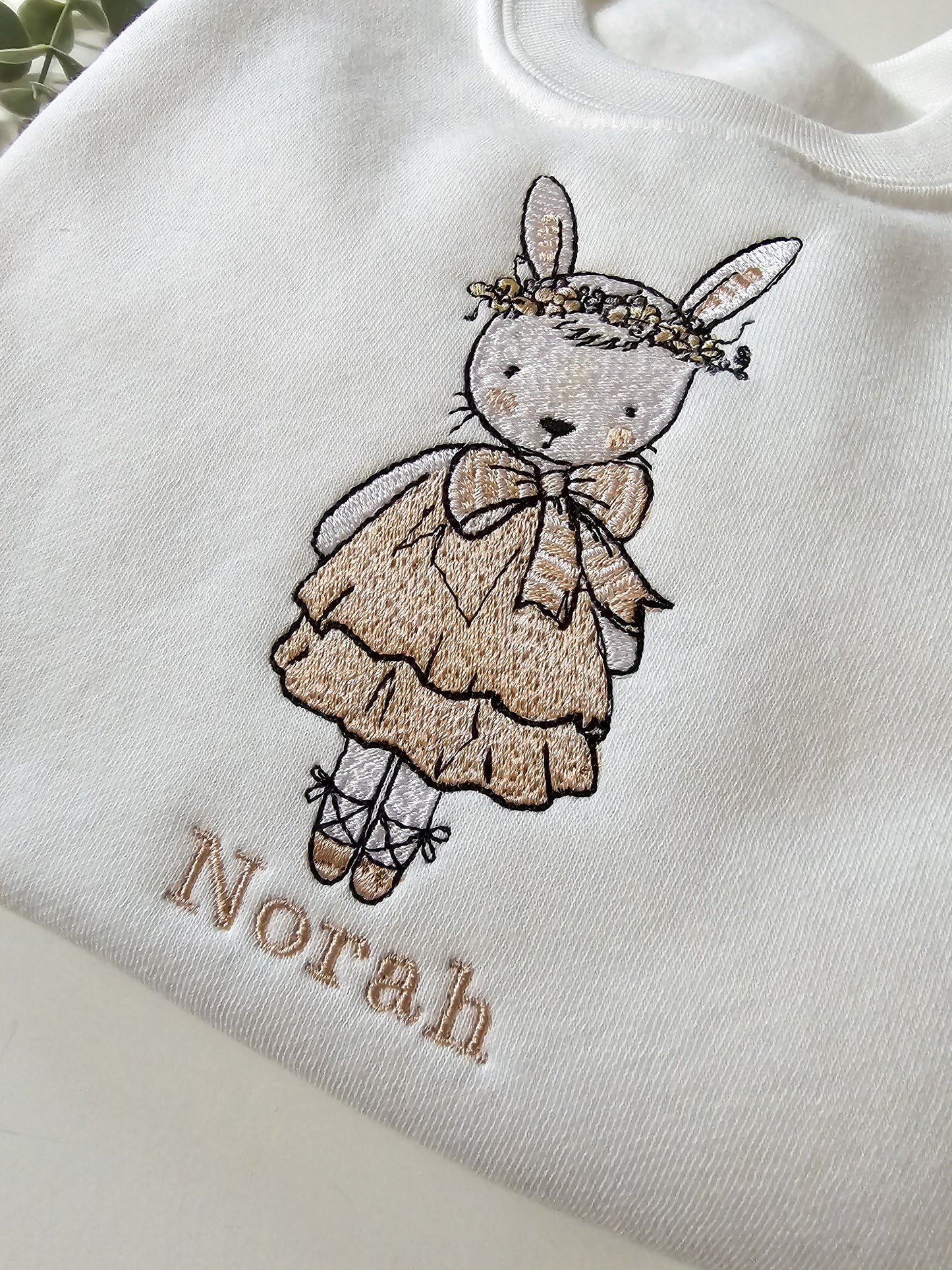 Personalised white children’s jumper with embroidered bunny wearing pink dress and floral flower crown with child’s name