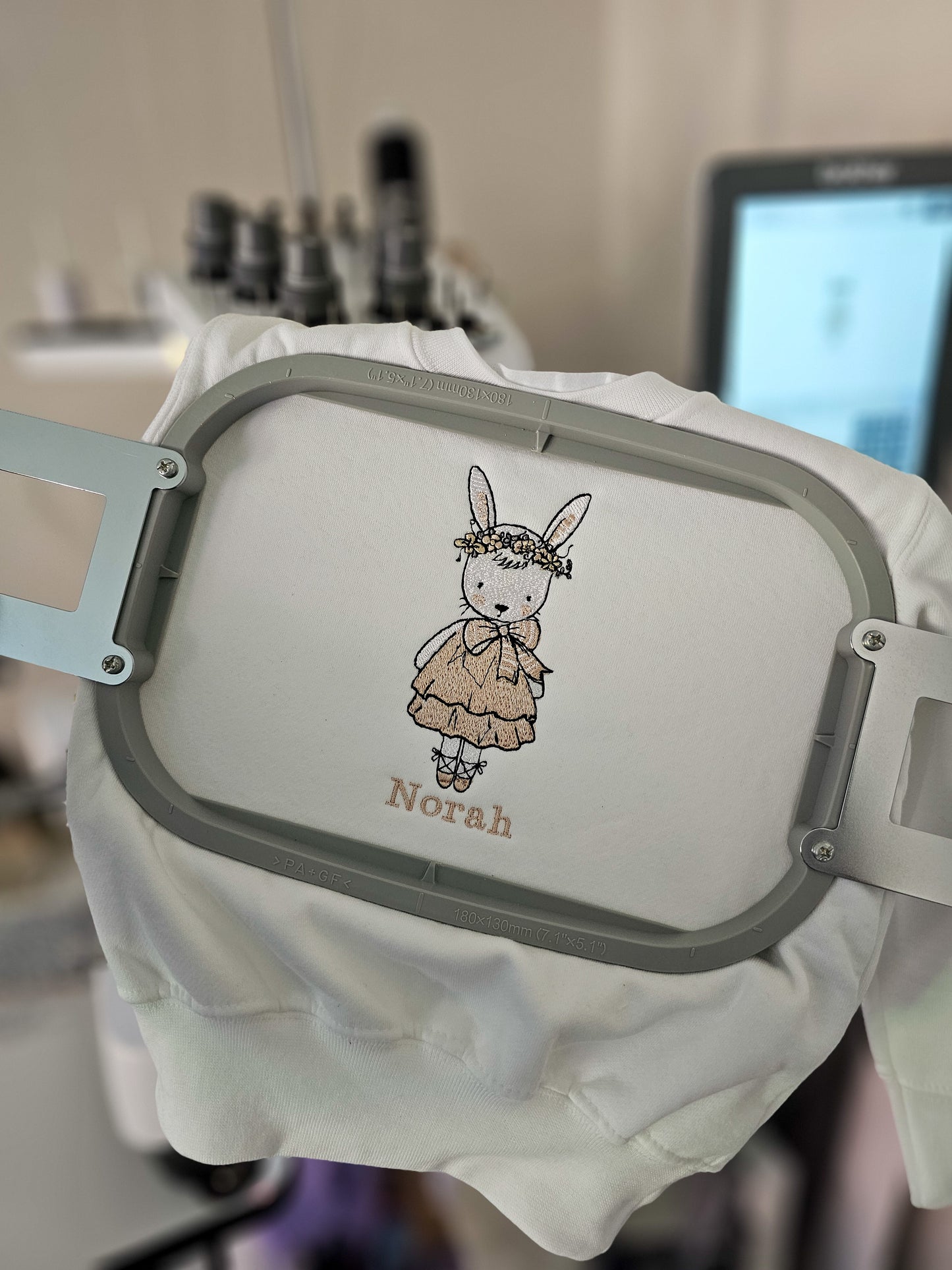 Personalised white children’s jumper with embroidered bunny wearing pink dress and floral flower crown with child’s name