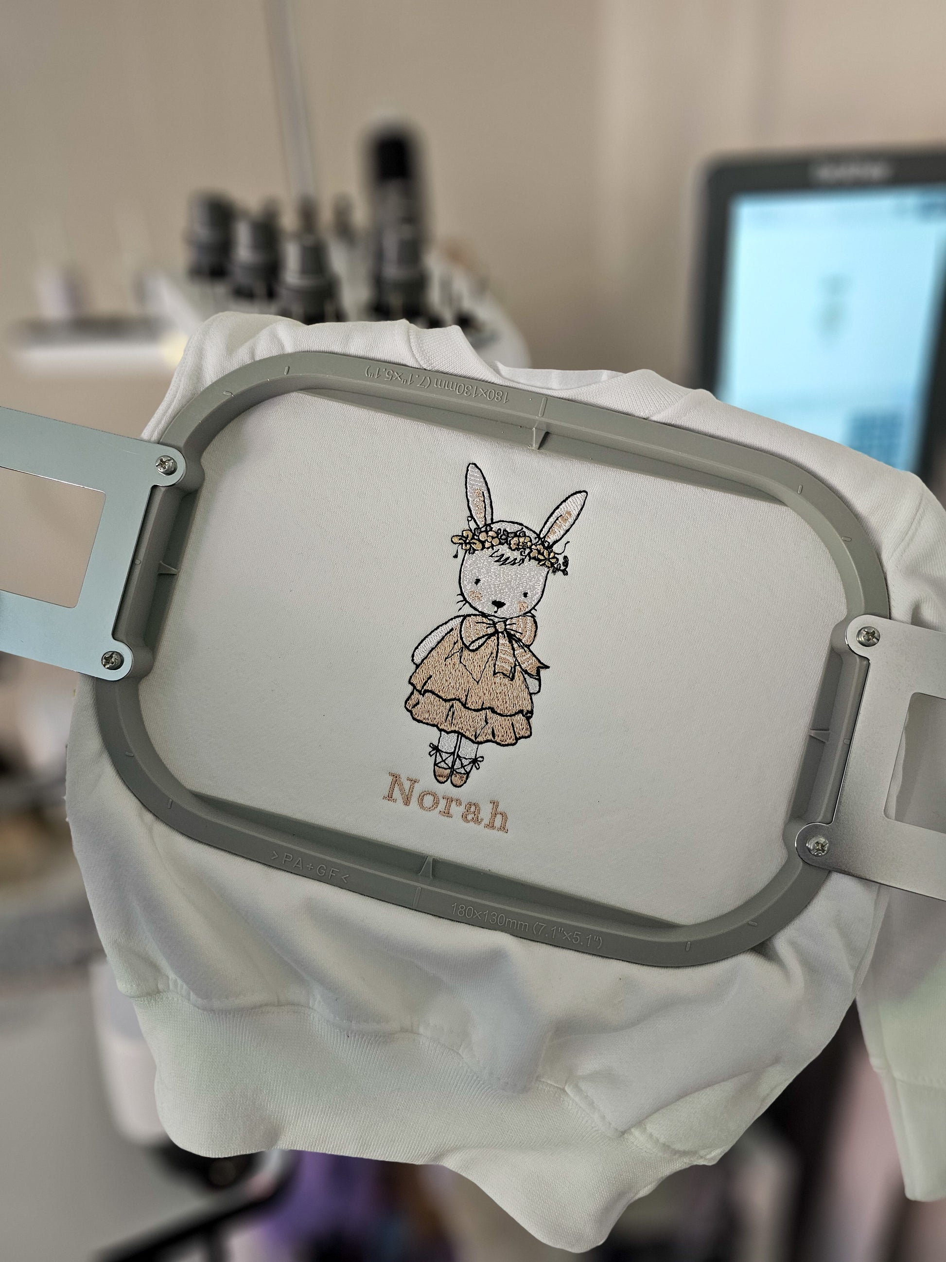 Personalised white children’s jumper with embroidered bunny wearing pink dress and floral flower crown with child’s name