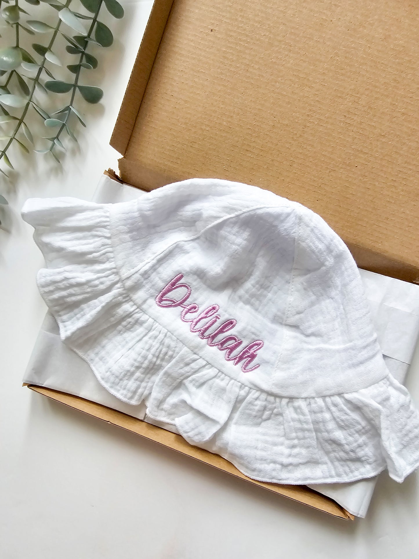 Personalised, embroidered baby sun hat with purple thread.
