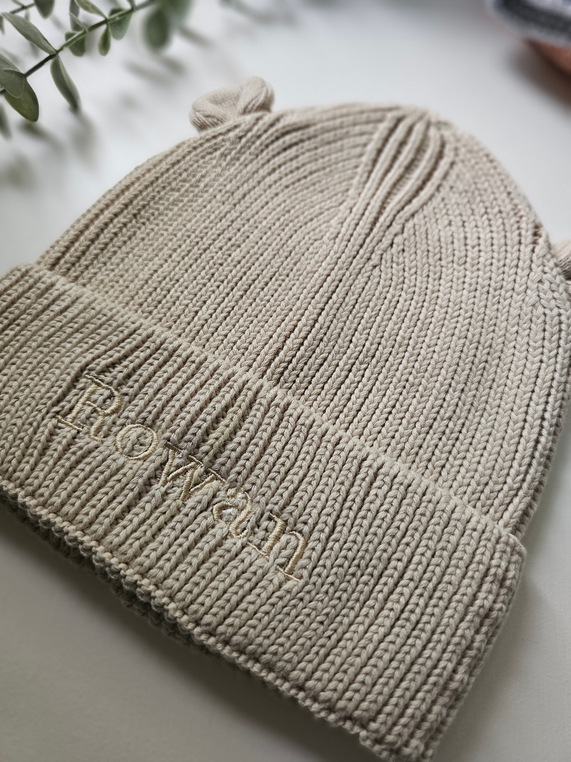 Beige ribbed knit baby beanie with 3D bear ear. Personalised with child's name in embroidery.